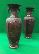 A pair of 19th Century Japanese chocolate patinated bronze vases with relief work decoration of