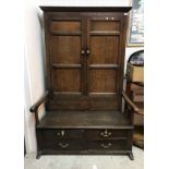 A circa 1800 oak bacon settle,