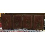 A circa 1900 red lacquered and gilt decorated Chinese four fold screen each panel decorated with