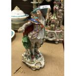 A 19th Century Continental porcelain figure of a gentleman in gilt decorated costume with dog at