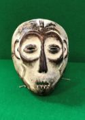 A 20th Century carved wood and painted tribal mask Congo Kivu Lega tribe