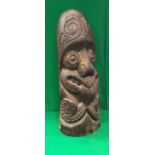 A 20th Century Polynesian style carved hard wood Tiki post head with tattooed face grimacing with