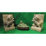 A pair of grey hardstone book ends as Dogs of Fo with balls together with a modern green jade