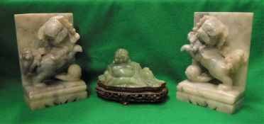 A pair of grey hardstone book ends as Dogs of Fo with balls together with a modern green jade