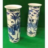 A pair of 19th Century Chinese blue and white cylindrical vases with flared rims,