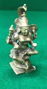 A 19th Century Indian cast bronze figure of a seated four armed deity