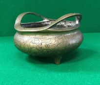 A 19th Century Chinese bronze censer with all over decoration of four toed dragons raised on three