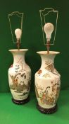 A pair of 19th Century Chinese polychrome decorated vases with relief work lion mask ring handles,