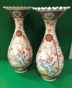 A pair of 19th Century Japanese Meiji Period Kutani baluster shaped vases with flared crimped rims,
