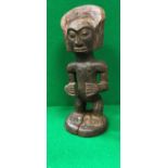 A vintage carved and stained African wooden ancestor figure with ornate headdress (possibly Songe