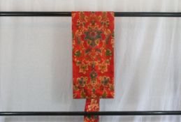 A circa 1960 silk semi-formal Nagoya obi with Hana (flower) green decoration on a red ground