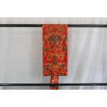 A circa 1960 silk semi-formal Nagoya obi with Hana (flower) green decoration on a red ground