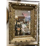 A foliate decorated swept framed mirror