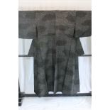 A circa 1950 semi-formal Oshima silk kimono with Nami ni Kumo (Wave and cloud) design on a black