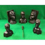 A pair of 20th Century African carved ebony book ends of bust form together with three further