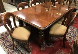 A modern reproduction mahogany extending dining table in the Victorian manner the top with moulded