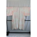 A circa 1970 silk single lady's kimono with pink Yuri (Lily) decoration on a cream and pink,