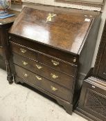 An early to mid 18th Century oak bureau of small proportions,