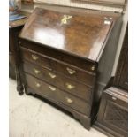 An early to mid 18th Century oak bureau of small proportions,