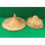 A Benares brass tray together with two Vietnamese raffia and leaf sun hats