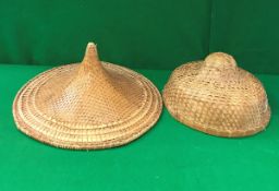 A Benares brass tray together with two Vietnamese raffia and leaf sun hats