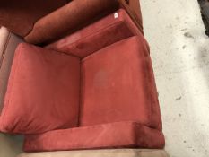 A modern red suede effect covered armchair and ottoman stool by Industrie Natuzzi