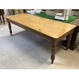 A modern pine farmhouse style kitchen table in the Victorian manner