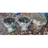 A pair of reconstituted stone garden urns and an octagonal garden urn