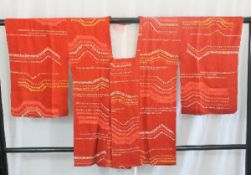 A circa 1960 silk haori (jacket) with So-Shibori (tie-dyed) yellow and white decoration on a red