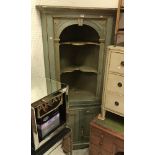 A duck egg blue and gilt decorated corner cupboard in the Georgian taste with open shelving over