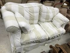 A modern upholstered scroll arm sofa with striped upholstery