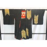 A circa 1930 silk haori (jacket) with gold Ya (arrow) decoration on a black ground,