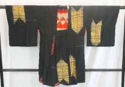 A circa 1930 silk haori (jacket) with gold Ya (arrow) decoration on a black ground,