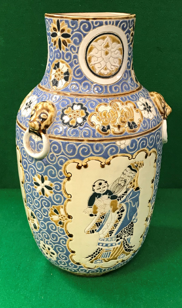 A 20th Century Vietnamese blue and brown glazed vase with incised decoration of panels of figures