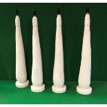 A collection of four plaster of Paris table lamps (believed to be castings of leather and