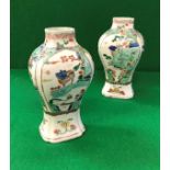 A pair of Chinese Kangxi square baluster shaped vases in famille-verte palette,