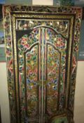 A 20th Century Indian carved and painted teak doorway with a pair of doors and surround and all