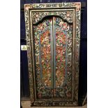 A 20th Century Indian carved and painted teak doorway with a pair of doors and surround and all