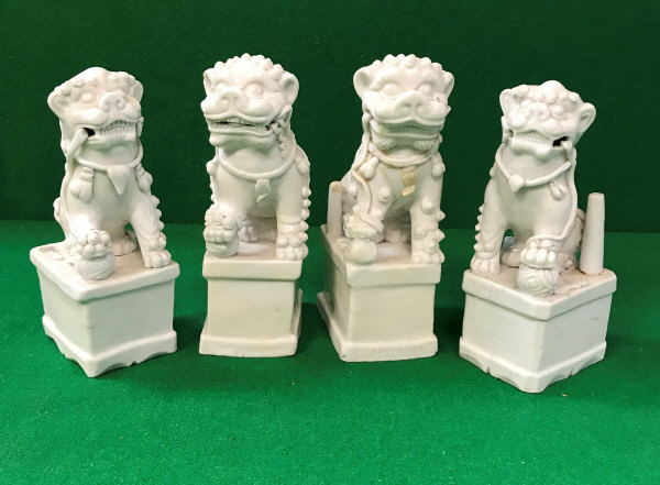 A collection of four Chinese blanc-de-chine figures of temple lions,