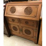 A modern Chinese teak bureau, the sloping fall over two drawers and two cupboard doors,