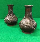 A pair of circa 1900 Chinese bronze baluster shaped vases chocolate patinated and decorated in