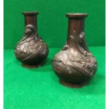 A pair of circa 1900 Chinese bronze baluster shaped vases chocolate patinated and decorated in