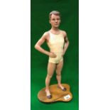 A vintage plastic advertising model of a man in swimwear/woollen underwear