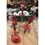 A cranberry glass epergne set on plated frame together with cranberry glass decanter with white