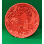 A modern Chinese cinnabar lacquered charger decorated with Shou Xin and children bringing forth a