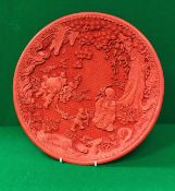 A modern Chinese cinnabar lacquered charger decorated with Shou Xin and children bringing forth a