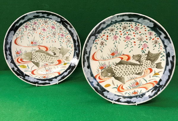 Two Japanese polychrome decorated plates, the centre field painted with carp and blossom,