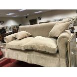 A modern fawn upholstered scroll arm two seat sofa