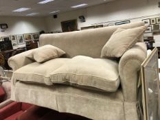 A modern fawn upholstered scroll arm two seat sofa