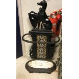 A Victorian cast iron umbrella stand with dog and armorial finial above a tiled back,